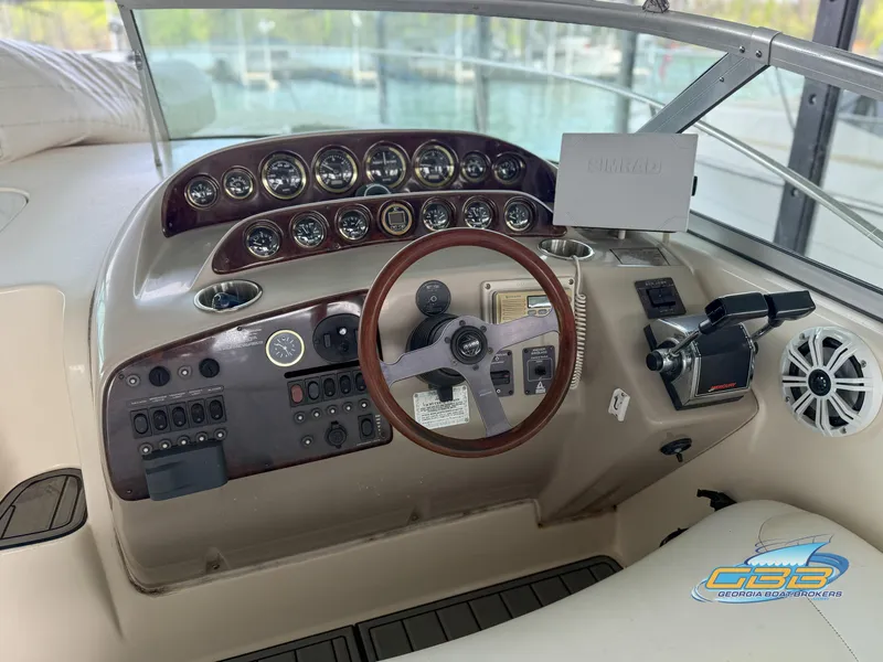 Slide: The Image of Cockpit of 2000 Rinker 340 Fiesta Vee with steering wheel and control panel. - 18