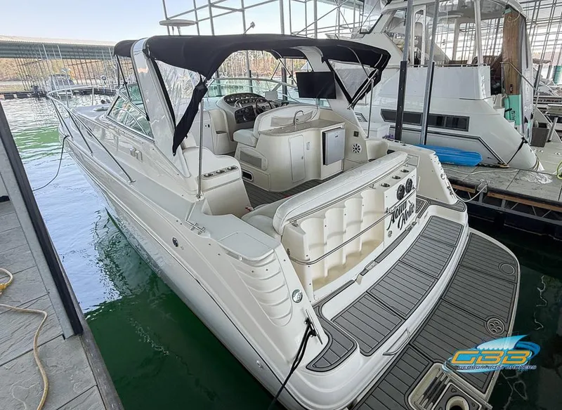 Slide: The Image of 2000 Rinker 340 Express Cruiser docked, featuring spacious seating and sleek design. - 19