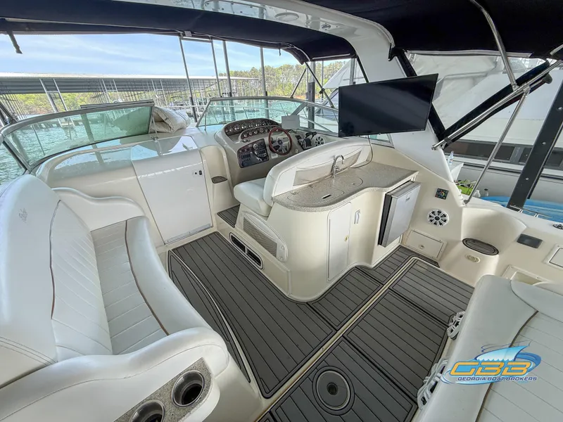 Slide: The Image of 2000 Rinker 340 Fiesta Vee boat interior with seating, helm, and modern amenities. - 21