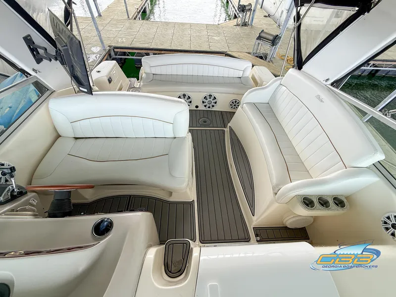 Slide: The Image of 2000 Rinker 340 Fiesta Vee boat interior with white seating and wood accents. - 22