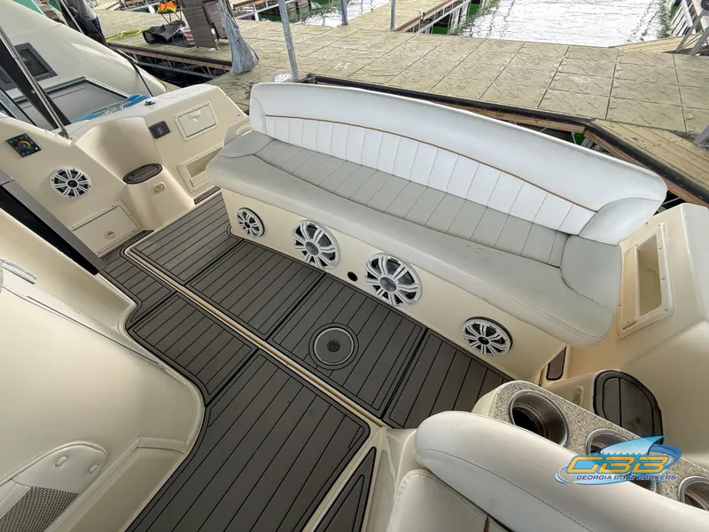 Slide: The Image of 2000 Rinker 340 Fiesta Vee boat interior with cushioned seating and modern speakers. - 23