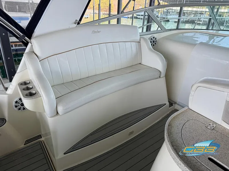 Slide: The Image of 2000 Rinker 340 Express Cruiser interior with white seating and modern design. - 24