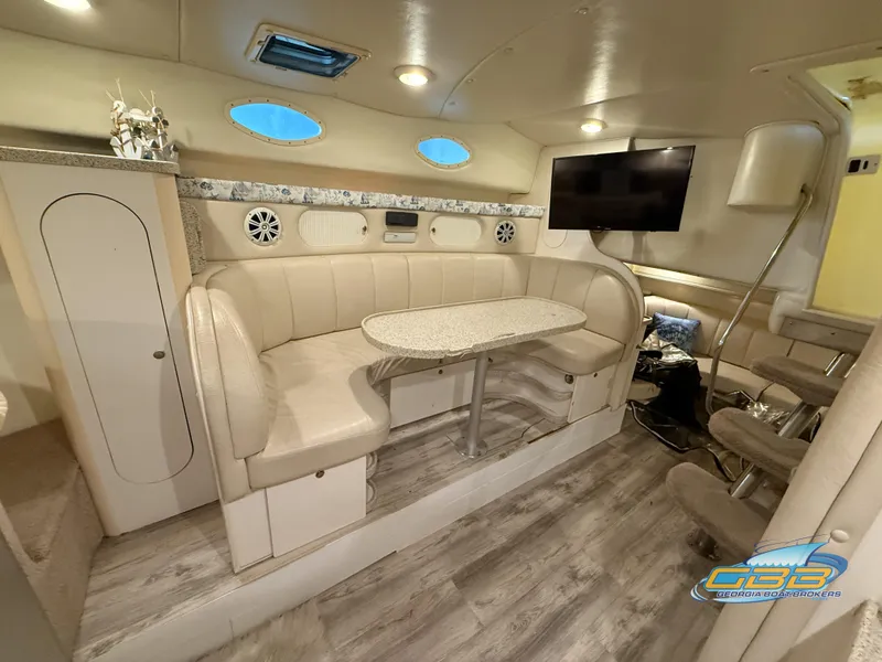 Slide: The Image of Interior of 2000 Rinker 340 Fiesta Vee with beige seating and modern amenities. - 27