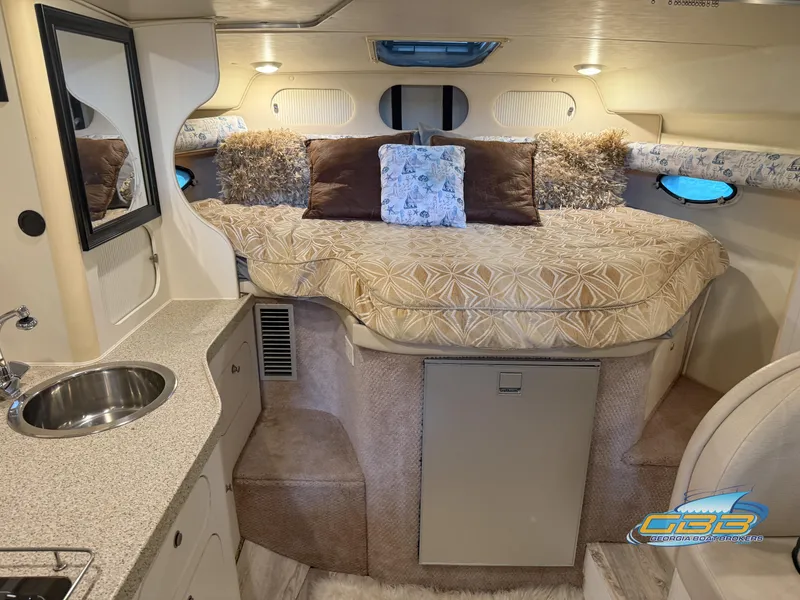 Slide: The Image of Interior of 2000 Rinker 340 Fiesta Vee boat with cozy bed and kitchenette. - 28