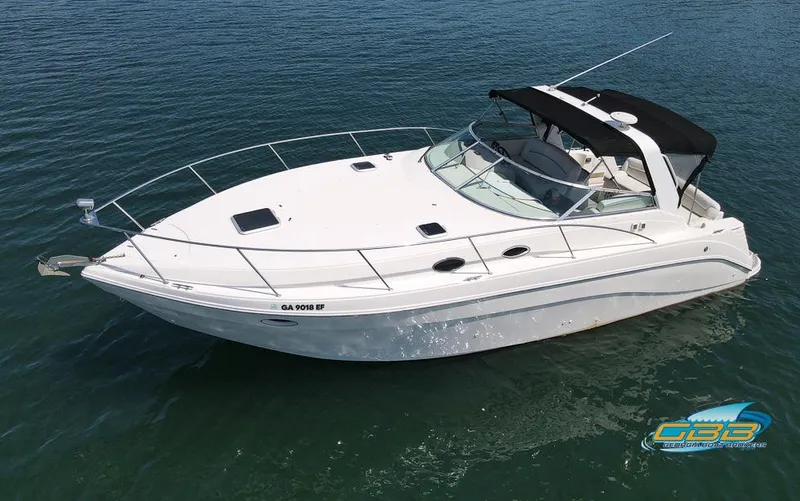 Slide: The Image of 2000 Rinker 340 Express Cruiser boat on calm water, featuring sleek design and black canopy. - 3