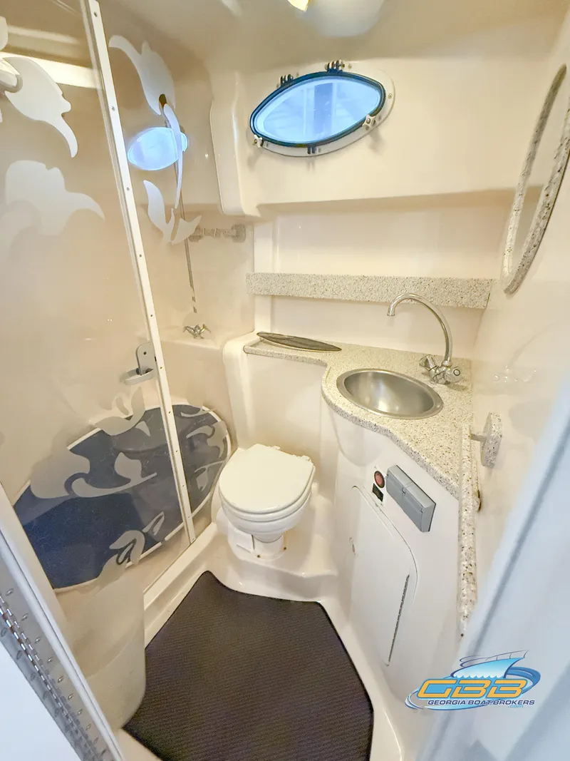Slide: The Image of 2000 Rinker 340 Fiesta Vee boat bathroom with shower, sink, and toilet. - 35