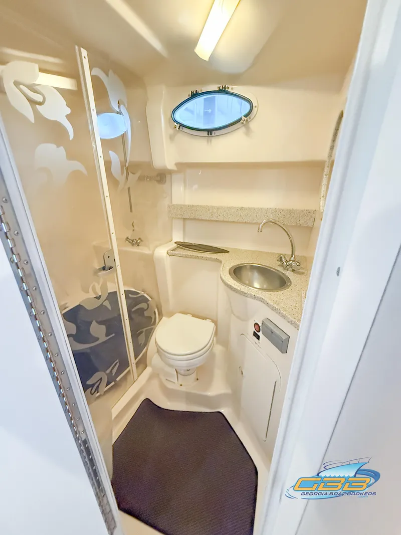Slide: The Image of 2000 Rinker 340 Fiesta Vee boat bathroom with shower, sink, and toilet. - 36