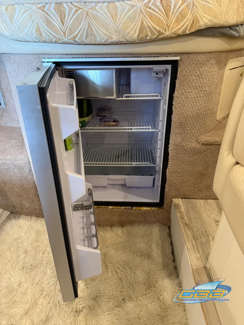 Slide: The Image of Open mini fridge inside 2000 Rinker 340 Fiesta Vee boat cabin. - 37