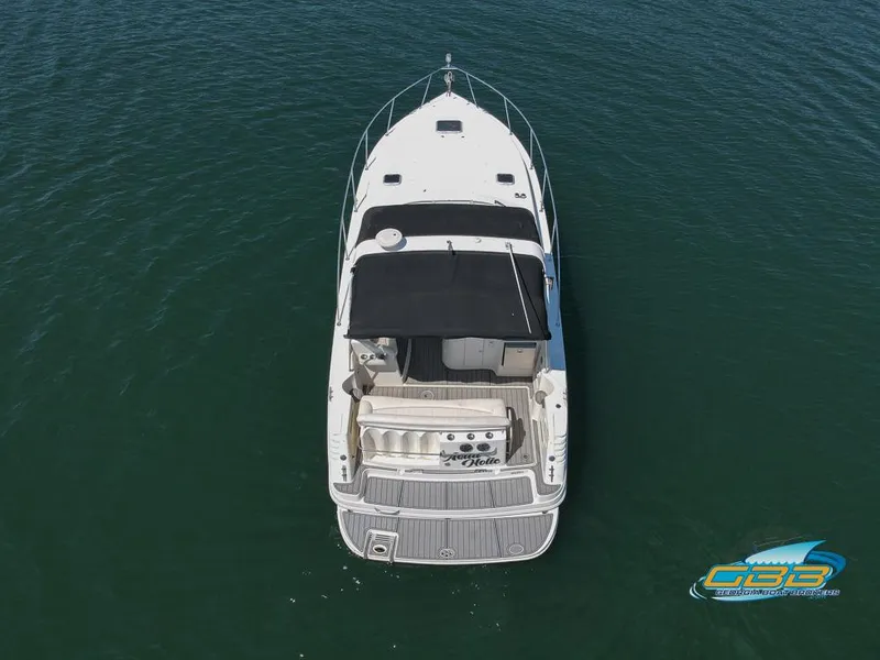Slide: The Image of 2000 Rinker 340 Express Cruiser on water, aerial view, black canopy, white deck. - 6