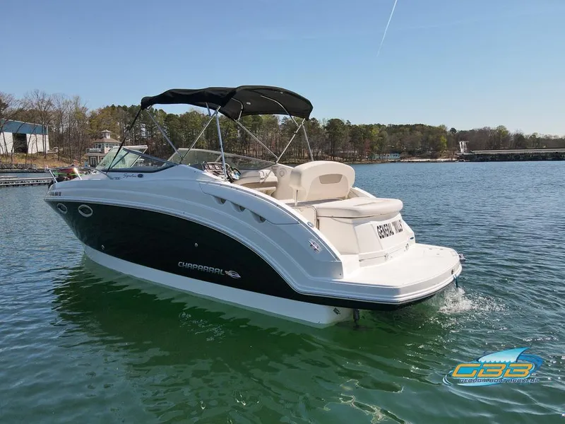 Slide: The Image of A 2008 Monterey 250 Cruiser boat on a lake with a forested shoreline. - 13