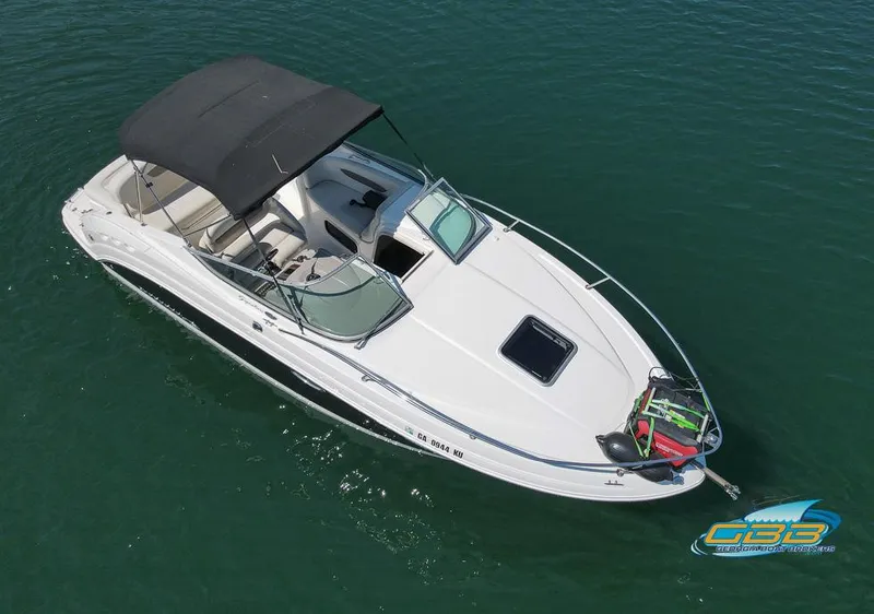 Slide: The Image of 2008 Monterey 250 Cruiser boat with black canopy on calm water. - 14