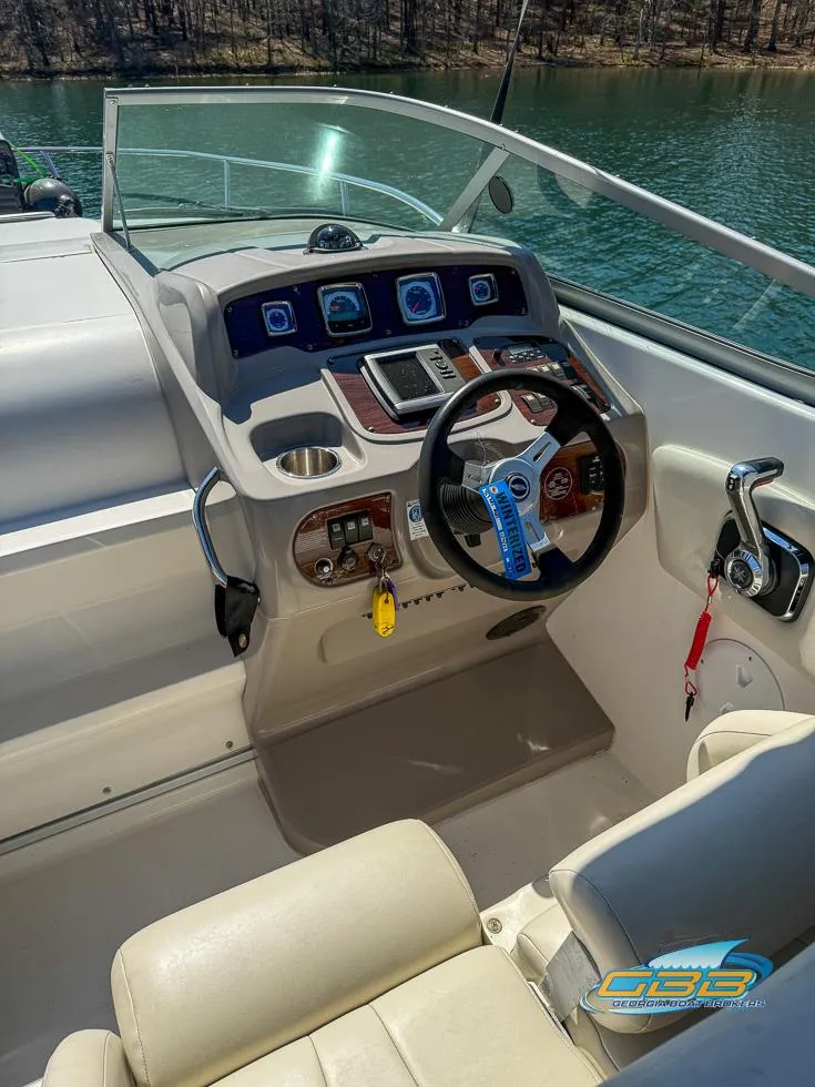 Slide: The Image of 2008 Monterey 250 Cruiser boat helm with steering wheel and control panel. - 16
