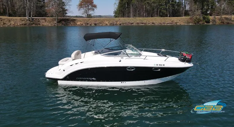 Slide: The Image of 2008 Monterey 250 Cruiser boat on a calm lake with trees in the background. - 2