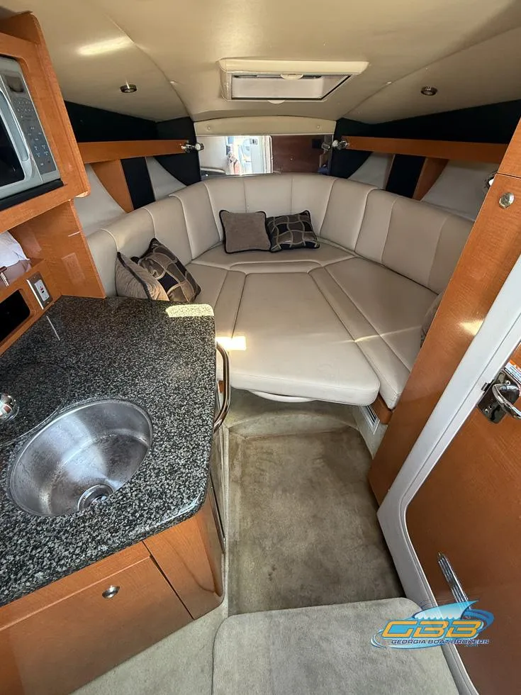 Slide: The Image of 2008 Monterey 250 Cruiser interior with cozy seating, kitchenette, and modern amenities. - 24