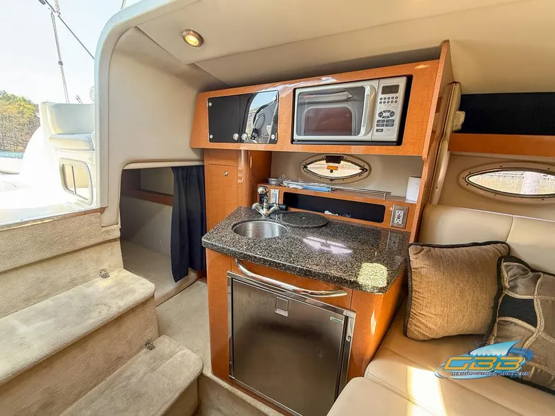 Slide: The Image of 2008 Monterey 250 Cruiser interior with kitchenette, microwave, sink, and seating area. - 29