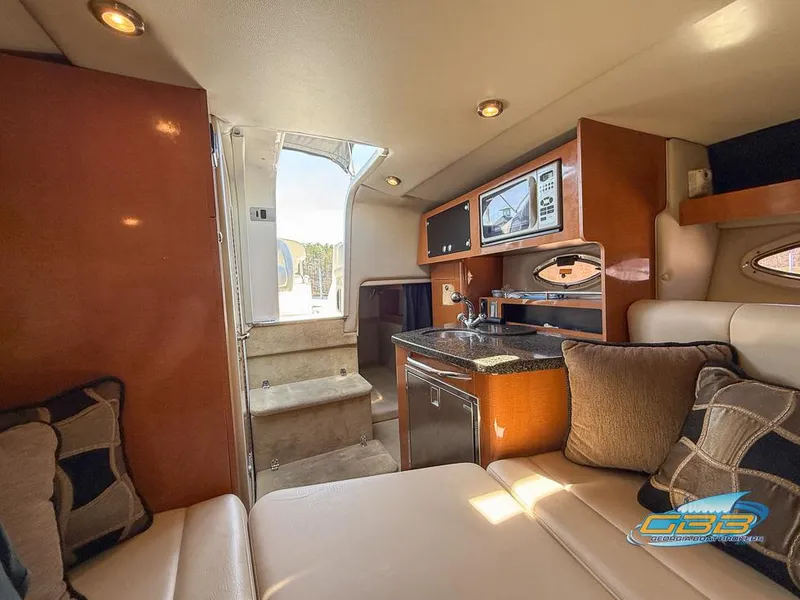 Slide: The Image of Interior of a 2008 Monterey 250 Cruiser boat with cozy seating and kitchenette. - 30
