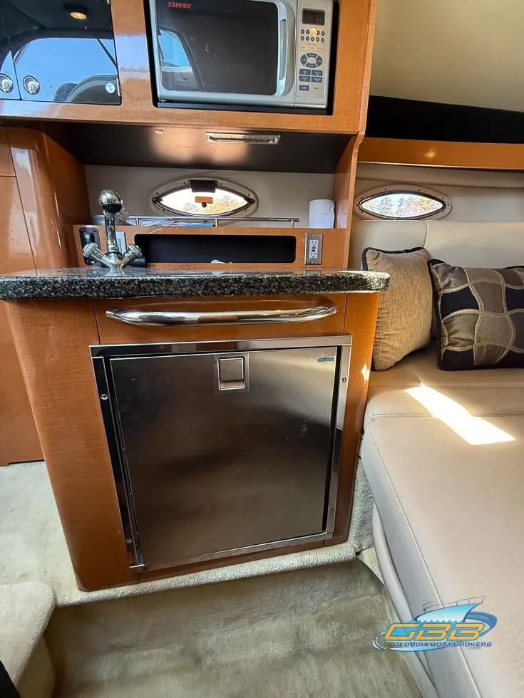 Slide: The Image of 2008 Monterey 250 Cruiser interior with kitchenette, microwave, and seating area. - 34