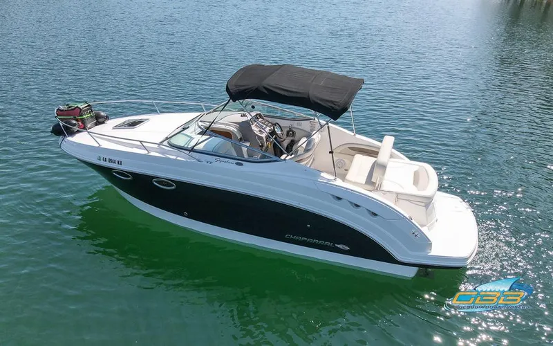 Slide: The Image of 2008 Monterey 250 Cruiser boat on calm water with black canopy. - 5