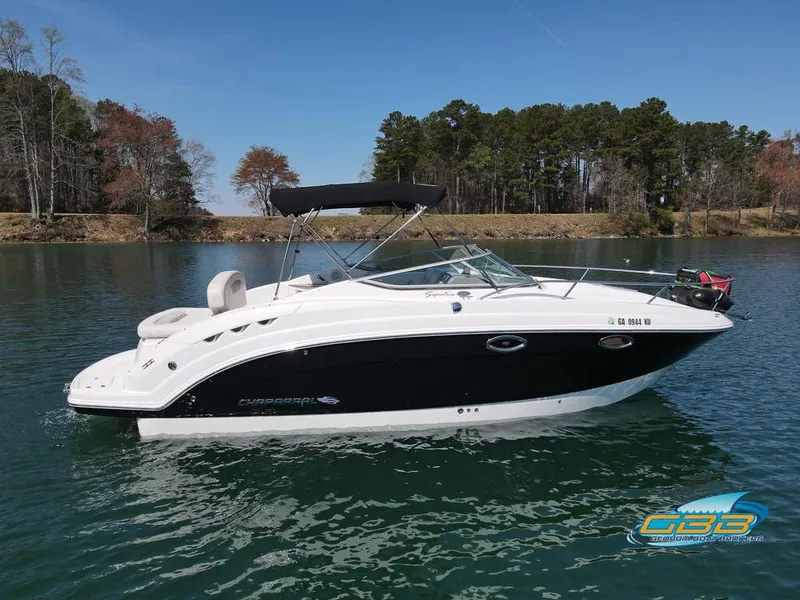 Slide: The Image of 2008 Monterey 250 Cruiser boat on a calm lake with trees in the background. - 8
