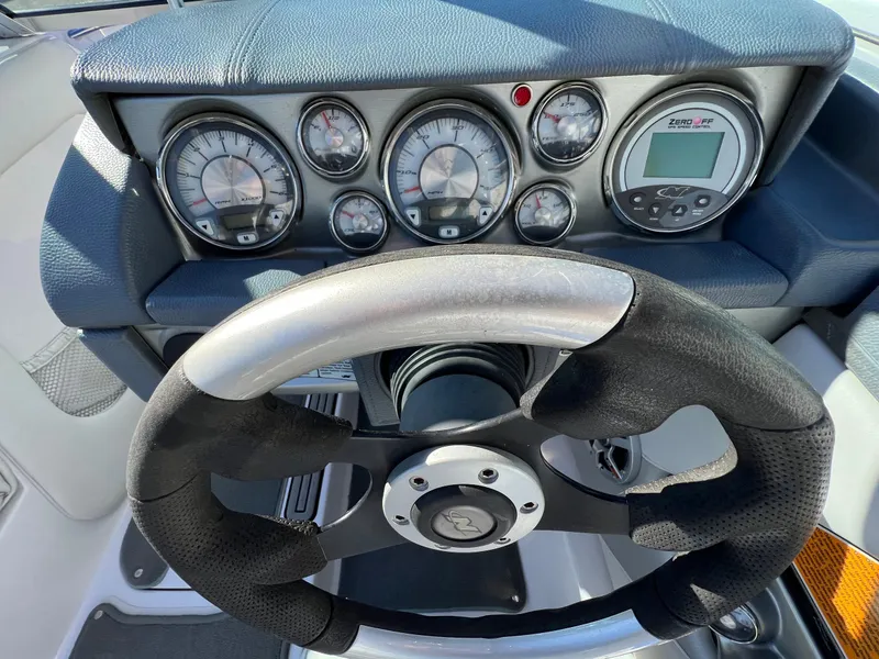 Slide: The Image of Steering wheel and dashboard of 2008 Nautique 210 boat with gauges and controls. - 20
