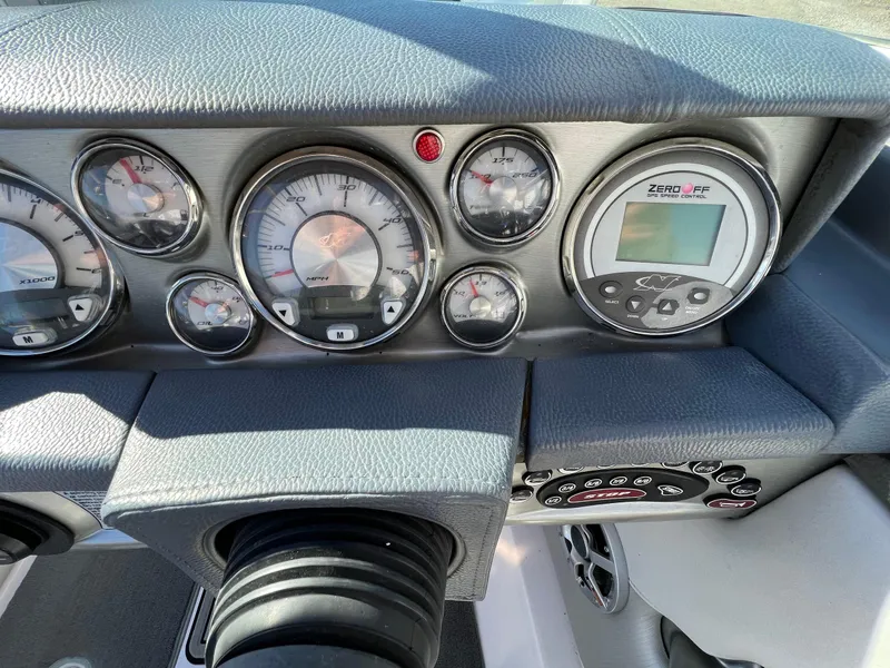 Slide: The Image of Dashboard of a 2008 Nautique 210 boat with gauges and controls. - 22