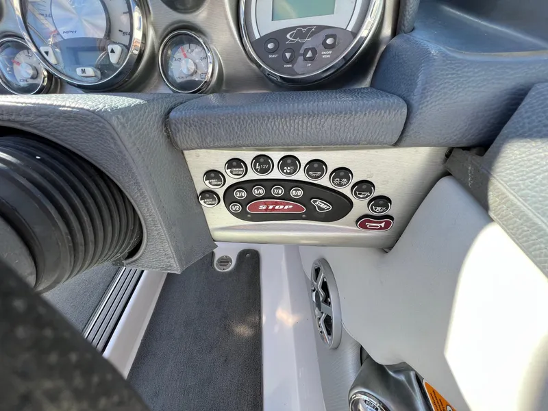 Slide: The Image of 2008 Nautique 210 boat dashboard with control panel and gauges. - 23