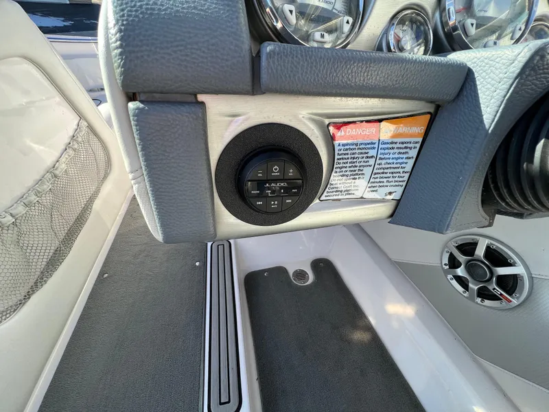 Slide: The Image of 2008 Nautique 210 boat dashboard with controls and warning labels. - 24