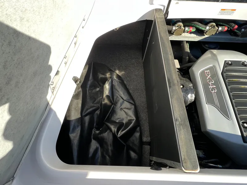 Slide: The Image of 2008 Nautique 210 engine compartment with EX343 engine, open storage area. - 28