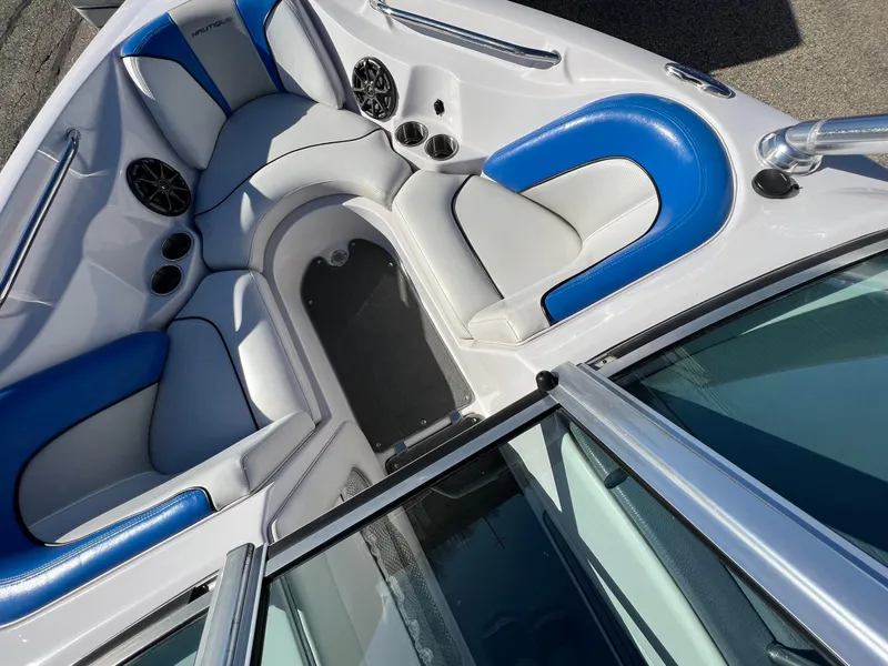 Slide: The Image of 2008 Nautique 210 boat interior with blue and white seating and speakers. - 30