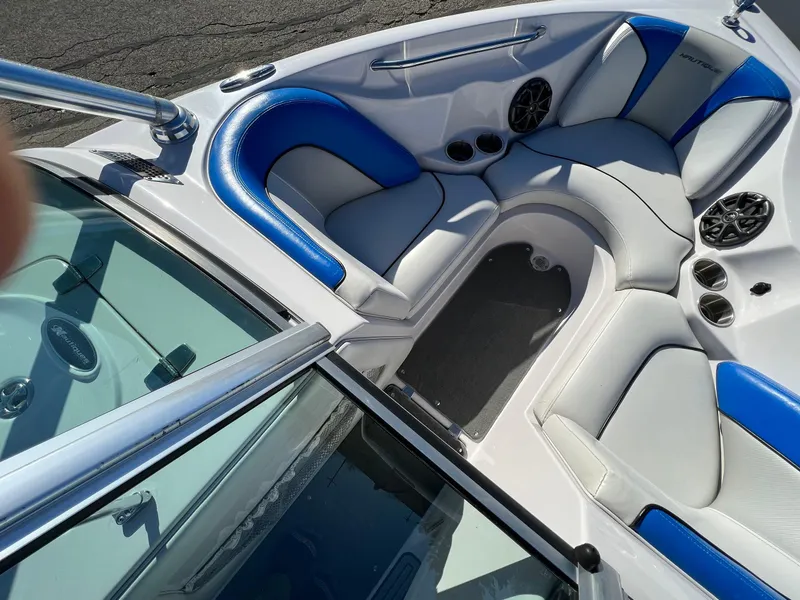 Slide: The Image of 2008 Nautique 210 boat interior with blue and white seating and speakers. - 31
