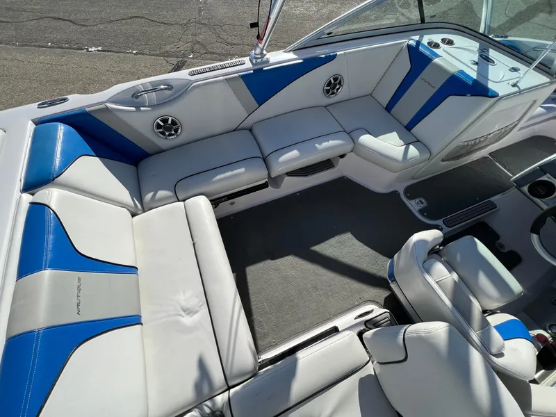 Slide: The Image of 2008 Nautique Super Air 210 boat interior with blue and white seating. - 16