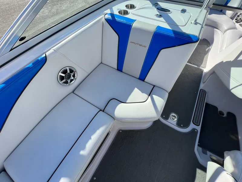 Slide: The Image of 2008 Nautique Super Air 210 boat interior with blue and white seating. - 17