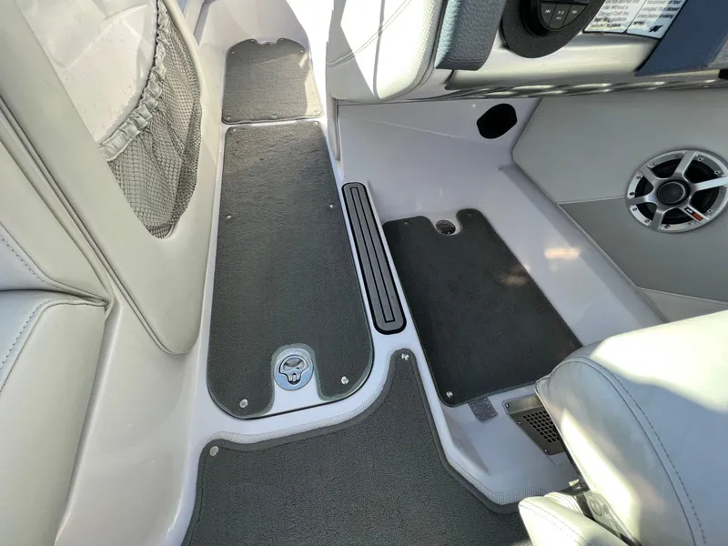 Slide: The Image of 2008 Nautique Super Air 210 interior with gray flooring and speaker detail. - 25