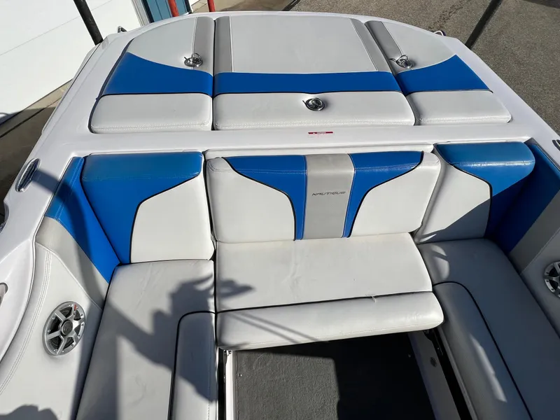 Slide: The Image of 2008 Nautique Super Air 210 boat interior with blue and white seating. - 26