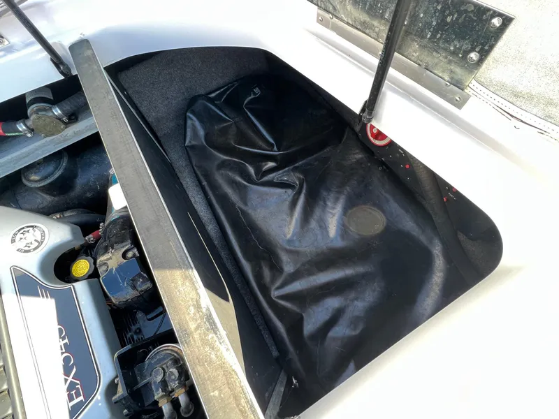 Slide: The Image of 2008 Nautique Super Air 210 engine compartment with black storage cover. - 29