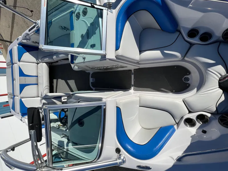 Slide: The Image of 2008 Nautique Super Air 210 boat interior with blue and white seating. - 33