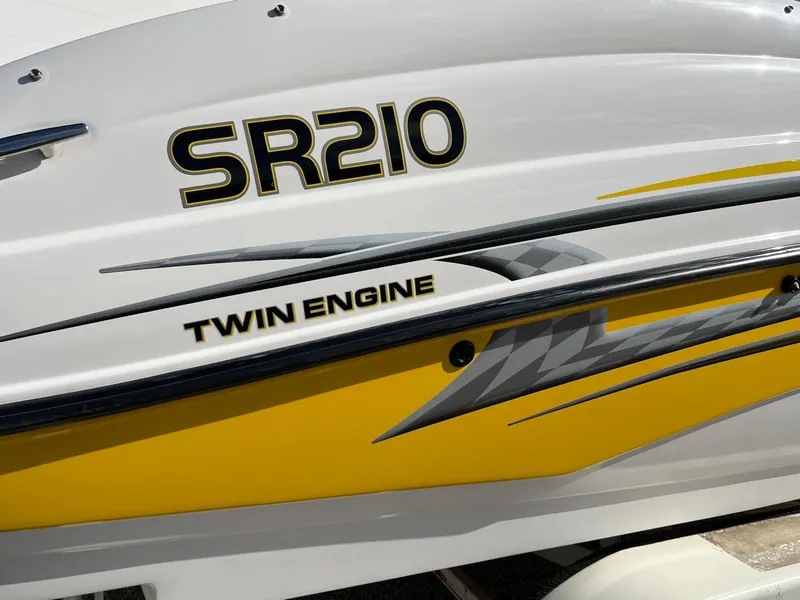 Slide: The Image of 2006 Yamaha Boats SR 210 with twin engine, featuring sleek yellow and gray graphics. - 1
