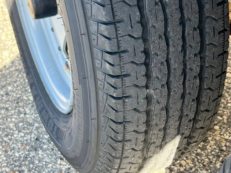 Slide: The Image of Close-up of a tire on a 2006 Yamaha Boats SR 210 trailer. - 10