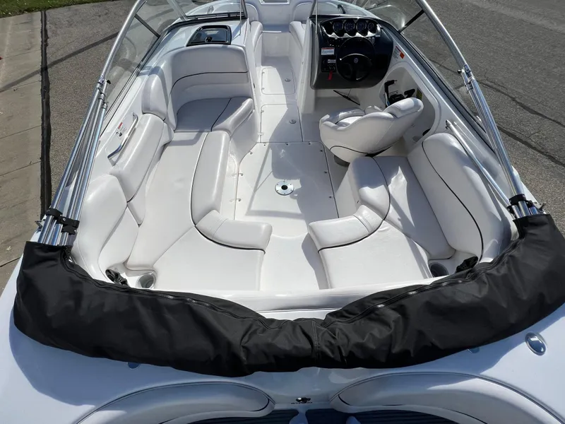 Slide: The Image of 2006 Yamaha Boats SR 210 interior with white seating and steering console. - 13