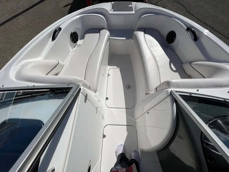 Slide: The Image of 2006 Yamaha Boats SR 210 interior with white seating and open bow design. - 14