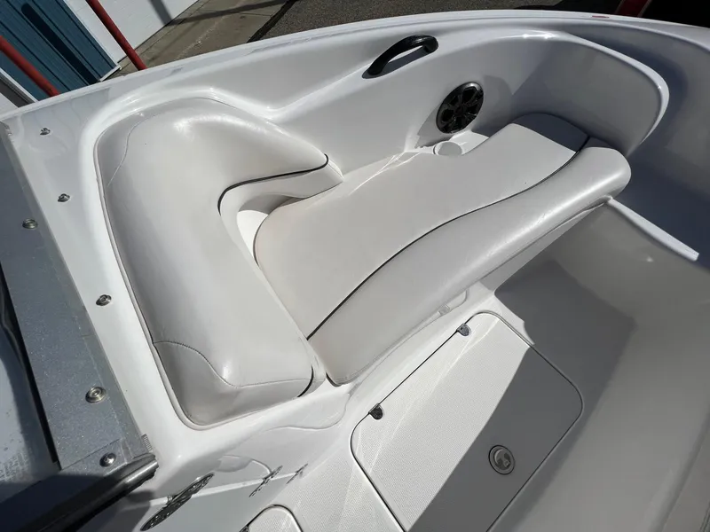 Slide: The Image of 2006 Yamaha Boats SR 210 interior with white seating and speaker detail. - 15
