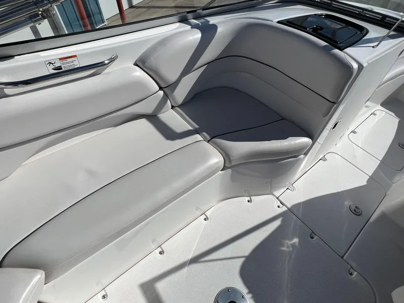 Slide: The Image of 2006 Yamaha Boats SR 210 interior seating with white upholstery and sleek design. - 19