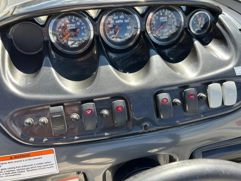 Slide: The Image of Dashboard of a 2006 Yamaha Boats SR 210 with gauges and control switches. - 21