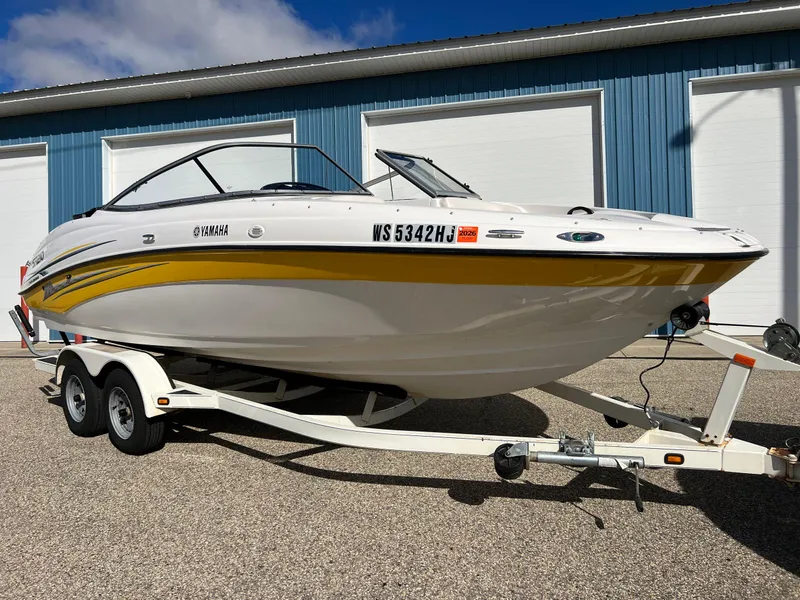 Slide: The Image of 2006 Yamaha Boats SR 210 on trailer, parked outdoors near blue building. - 3