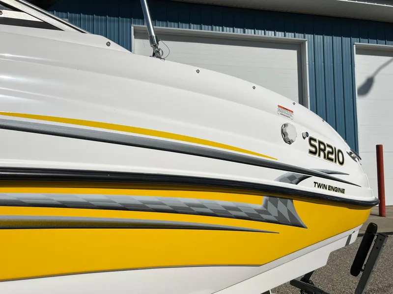 Slide: The Image of 2006 Yamaha Boats SR 210 with yellow and white design, twin engine. - 30