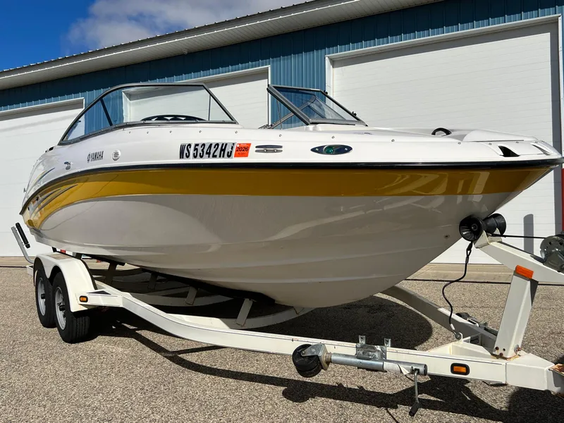 Slide: The Image of 2006 Yamaha Boats SR 210 on trailer, white and yellow, parked outdoors. - 5