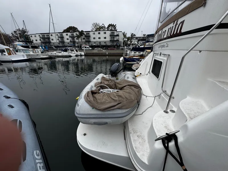 Slide: The Image of 1998 Sea Ray 370 Aft Cabin yacht docked with inflatable boat on deck. - 10