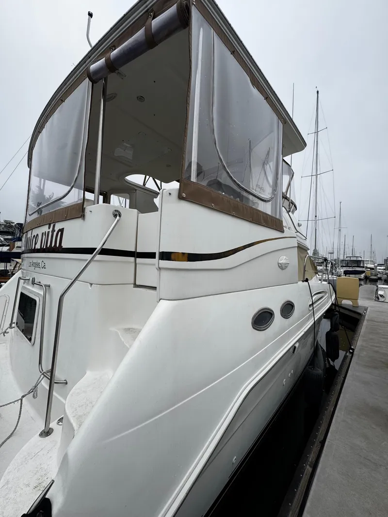 Slide: The Image of 1998 Sea Ray 370 Aft Cabin yacht docked at marina, side view. - 12