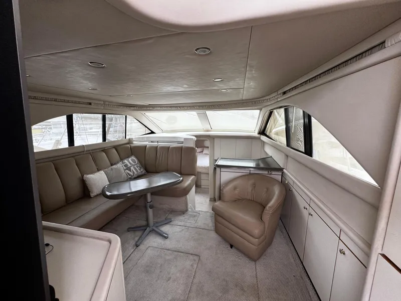Slide: The Image of Interior of 1998 Sea Ray 370 Aft Cabin yacht with beige seating and table. - 13