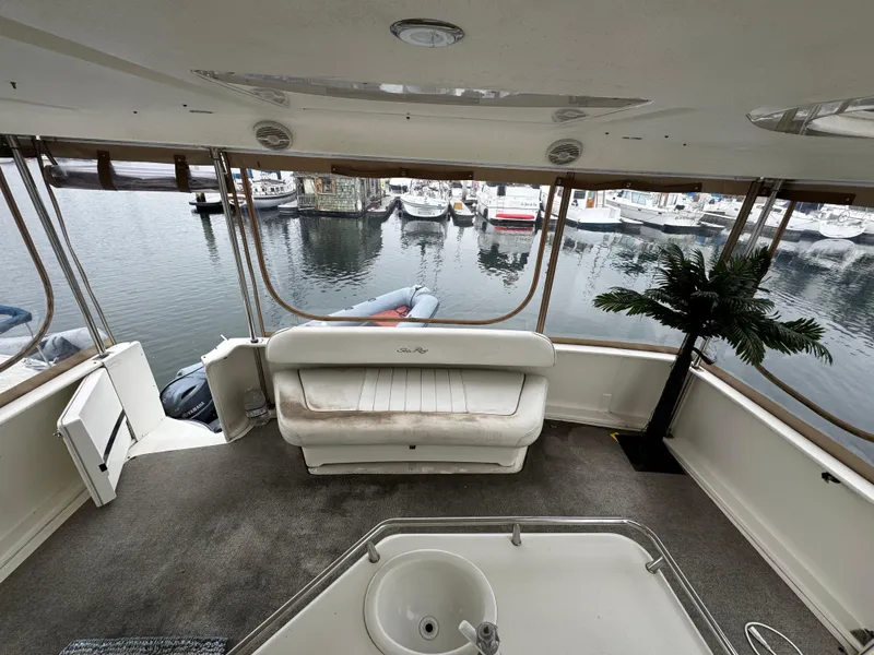 Slide: The Image of 1998 Sea Ray 370 Aft Cabin interior with seating, sink, and marina view. - 14